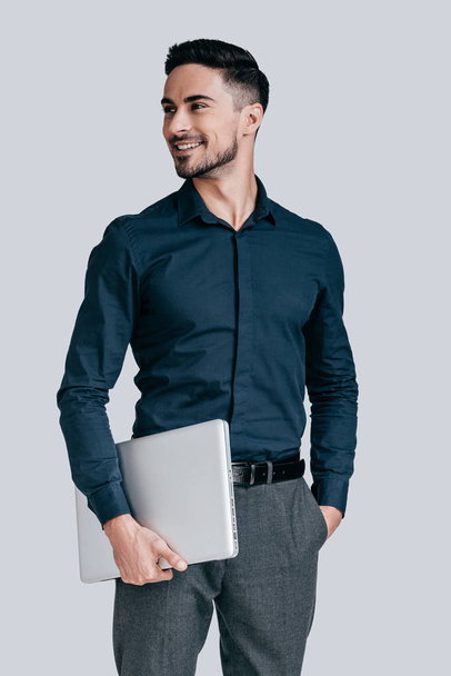 handsome man holding laptop - Fotoğraf, Görsel
