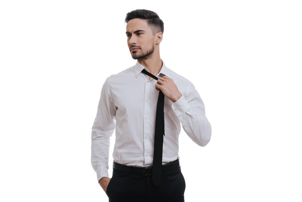 young businessman adjusting necktie - Fotó, kép