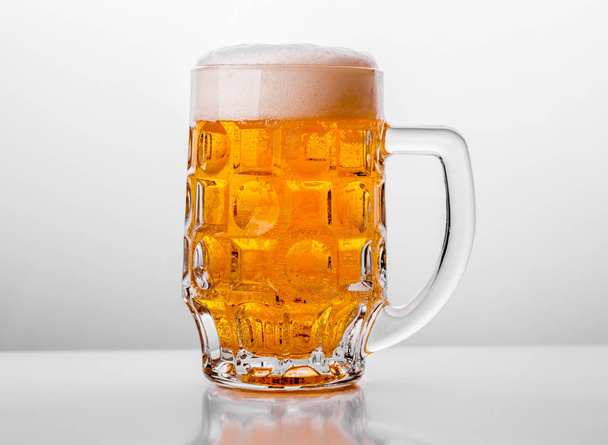 Glass of fresh beer on white background - Fotografie, Obrázek