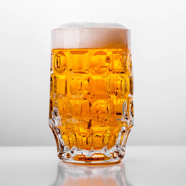 Glass of fresh beer on white background - Fotoğraf, Görsel