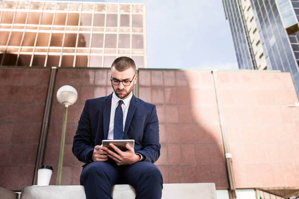 young businessman using a tablet computer - Fotó, kép