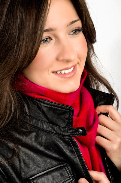 Portrait of young woman wearing black jacked and red scarf - Photo, image