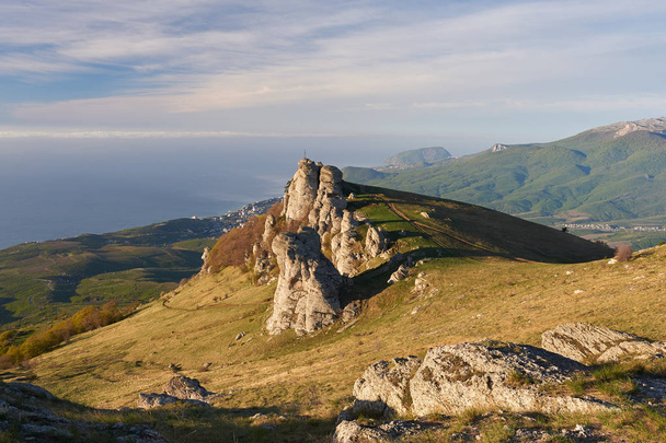 Summer landscape of the southern Crimea, overlooking the Black Sea and the surrounding mountains, in the bottom of Alushta. In the foreground weathered pillars called Valley of ghosts, Ukraine. - Fotó, kép