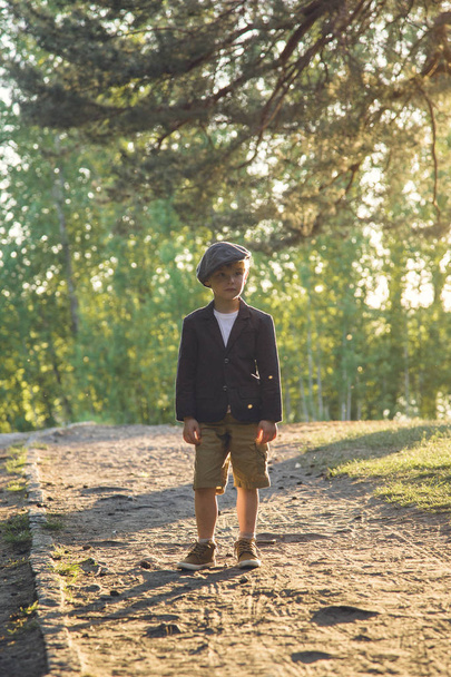 Молодой стильный мальчик в начале вечера со старомодной одеждой Retro, на открытом воздухе, сладкий и симпатичный
 - Фото, изображение