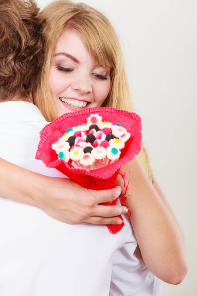 Couple with candy bunch flowers hugging. Love. - Фото, зображення