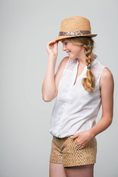 Smiling woman wearing summer straw fedora hat - Fotó, kép