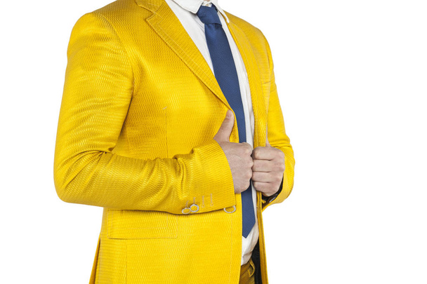 businessman in a gold suit stands profile - Foto, imagen