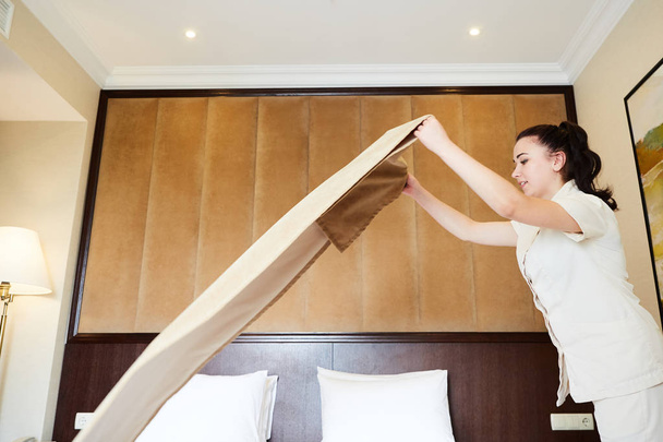 Hotel service. Made making bed in room. - 写真・画像