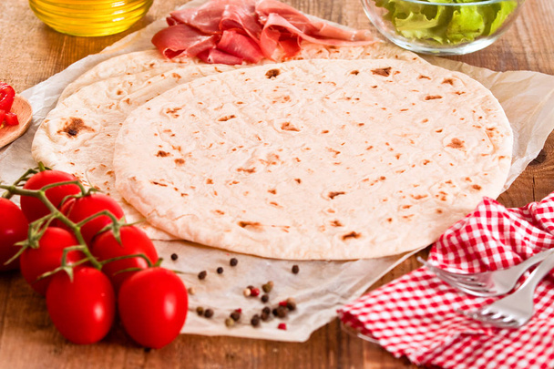 Piadina with ham and lettuce.  - Photo, Image