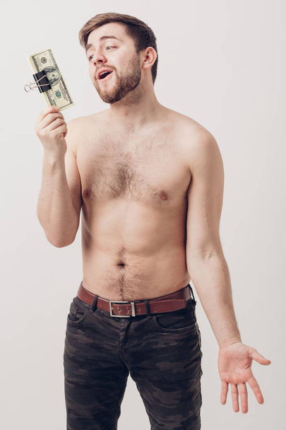 handsome smiling man with beard  holding a lot of hundred-dollar - Foto, imagen