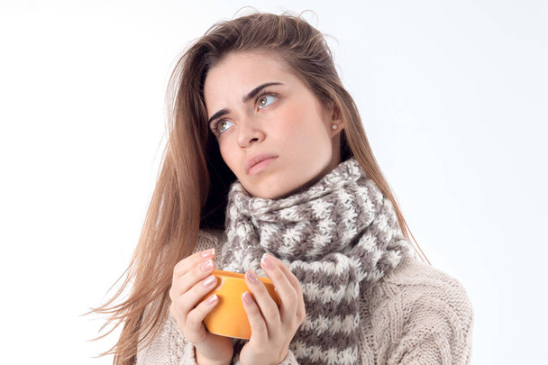 girl in  scarf and jacket looks into the distance  holding  cup isolated on white background - Φωτογραφία, εικόνα
