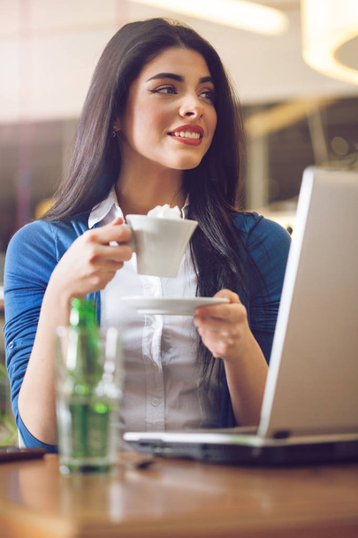 Portrait of woman with coffee cup at modern home office - Fotoğraf, Görsel