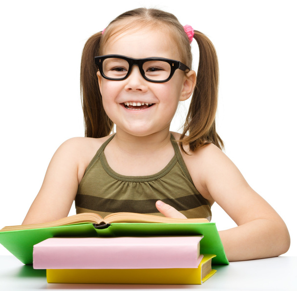 Cute cheerful little girl reading book - Foto, imagen