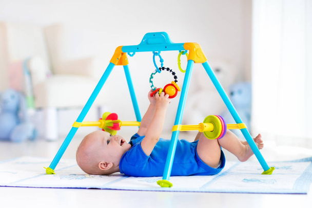 Baby boy on play mat. Child playing in gym. - Photo, Image