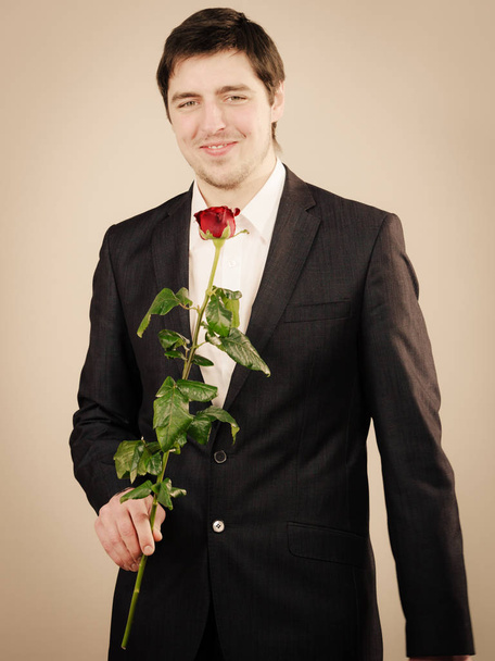Elegant young man with red rose. - Photo, image