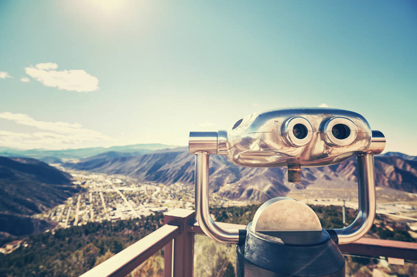 Color toned photo of binoculars looking out over a valley. - Photo, Image
