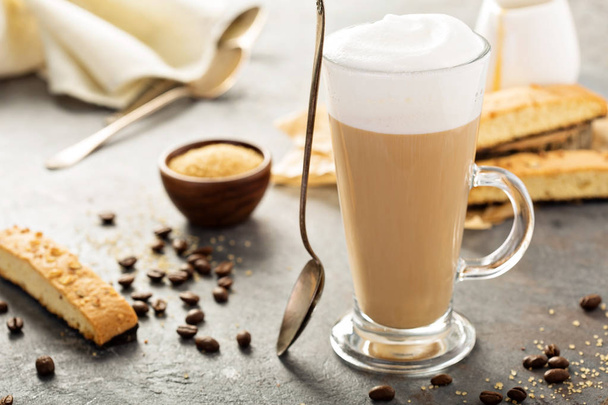 Hot coffee latte with biscotti cookies - 写真・画像