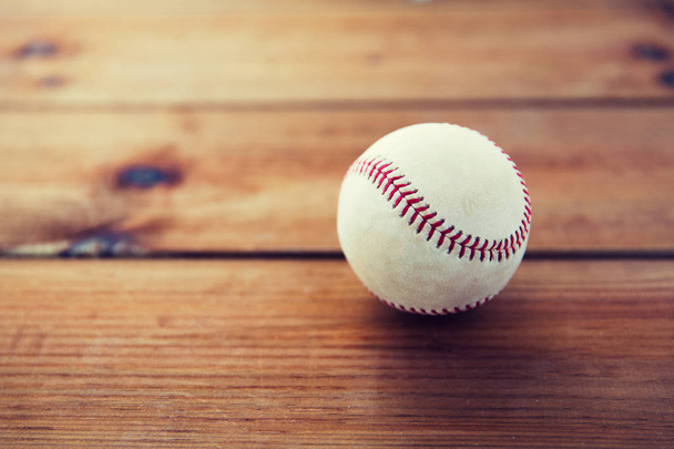 close up of baseball ball on wooden floor - Foto, Imagen