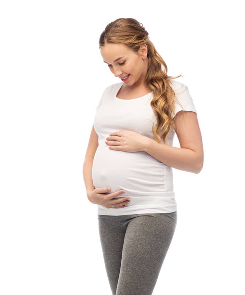 happy pregnant woman touching her big belly - Zdjęcie, obraz