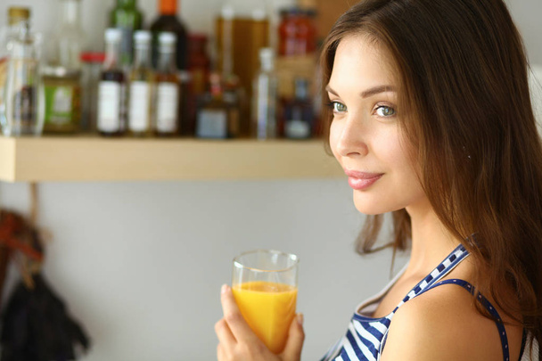 Portrait of a pretty woman holding glass with tasty juice - Valokuva, kuva