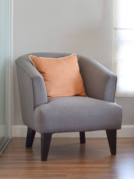 modern living room interior with orange pillow on grey armchair - Foto, Imagem