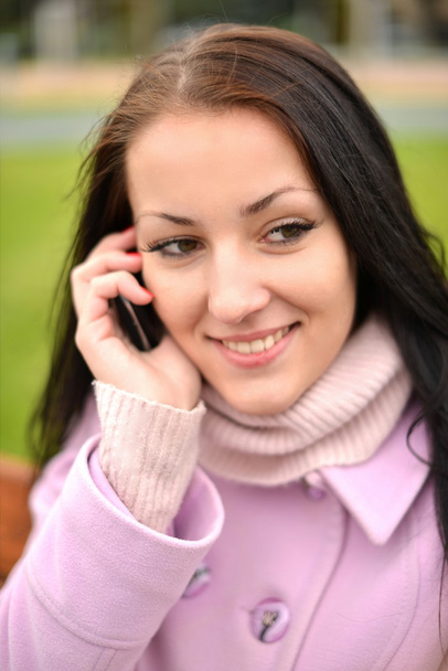 Beautiful young woman with mobile cell phone in city. Closeup, copyspace. - Fotoğraf, Görsel