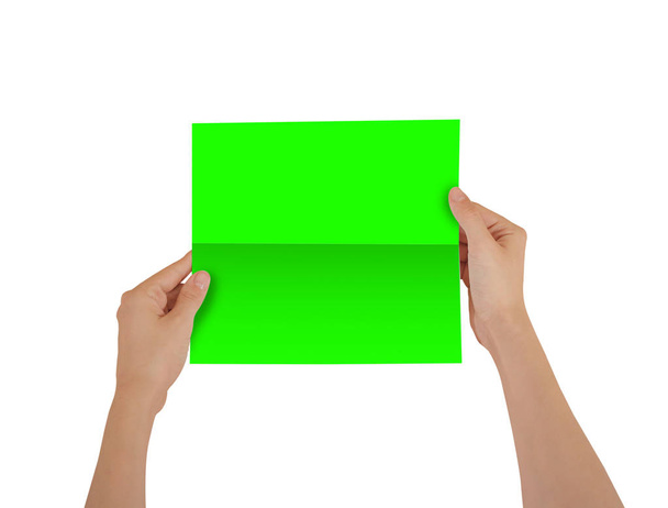 Hands holding blank green brochure booklet in the hand. Leaflet  - Φωτογραφία, εικόνα
