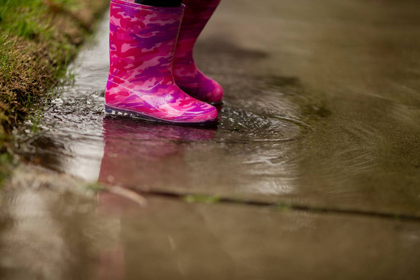 Een jong meisje speelt in de veel regen van Californië nodig. - Foto, afbeelding