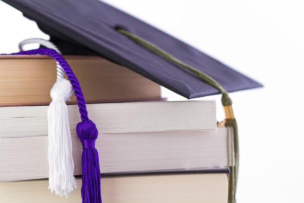 Cap and cords on books, achievement and education symbols - Photo, Image