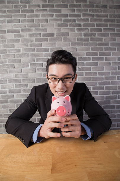 business man holding  piggy bank  - Fotoğraf, Görsel