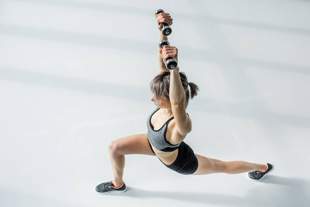Woman training with dumbbells - Photo, Image