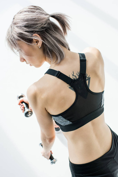 Woman training with dumbbells - 写真・画像