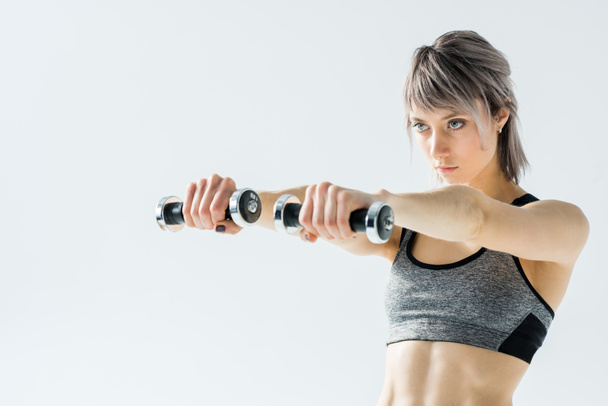 Woman training with dumbbells - Foto, afbeelding
