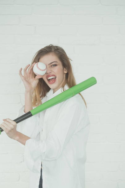 pretty sexy woman with long hair holds green baseball bat - Fotografie, Obrázek