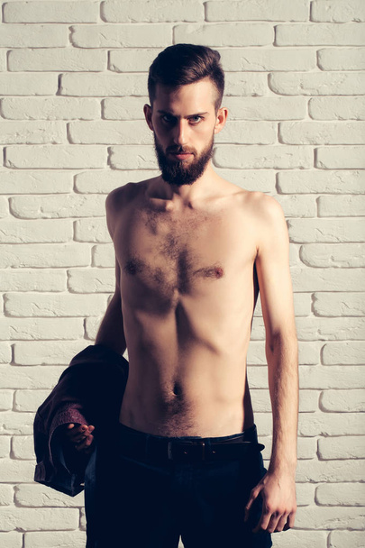 slim bearded man with thin bare torso on brick background - Φωτογραφία, εικόνα