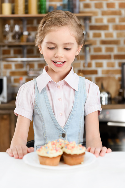 Little girl with cakes - Photo, Image