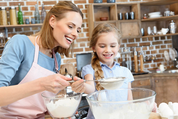 Mother and daughter preparing dough - Photo, Image