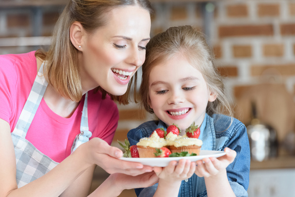 mother and daughter with pastry - Photo, Image