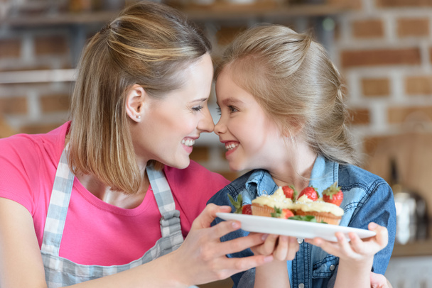 mother and daughter with pastry - Foto, afbeelding