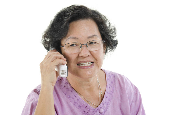 Senior adult woman on the phone - Foto, afbeelding