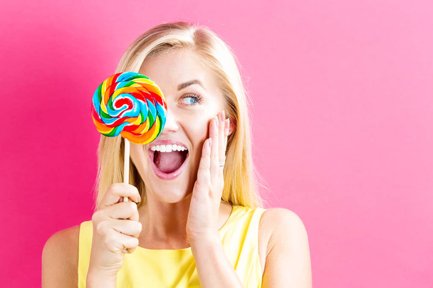 Woman holding lollipop - Foto, imagen
