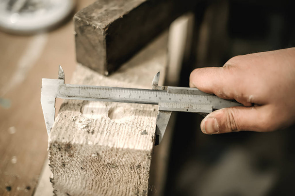 Carpenter using ruler for his job in carpentry workshop - Φωτογραφία, εικόνα