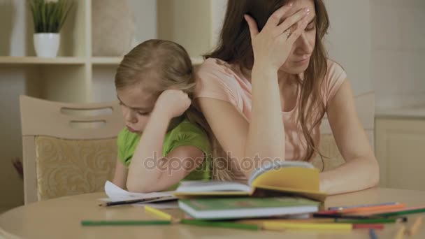 Sad mother and daughter having conflict, bored girl refusing to do homework - Felvétel, videó