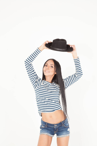 mulatto young woman with a black hat - Фото, изображение