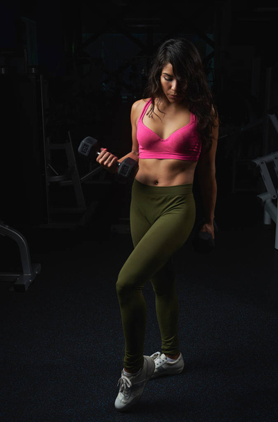 Woman holding weights - 写真・画像