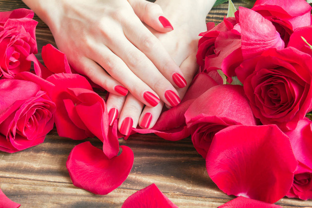 red nail manicure with red roses around - Photo, Image