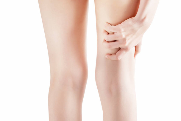 Acute pain in a woman thigh isolated on white background. Clipping path on white background. - Photo, Image
