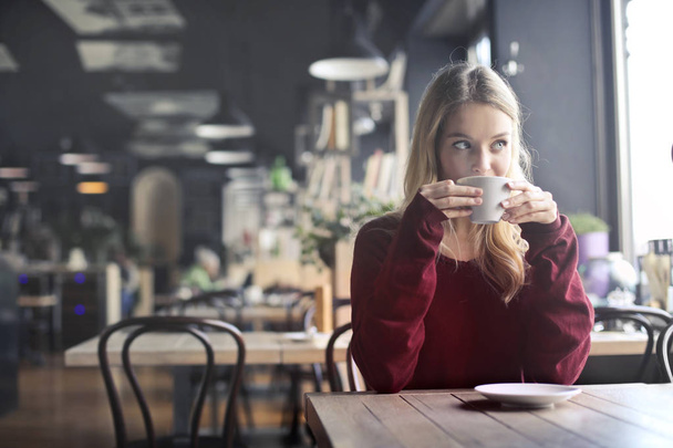 Blonde woman drinking coffee - Фото, зображення