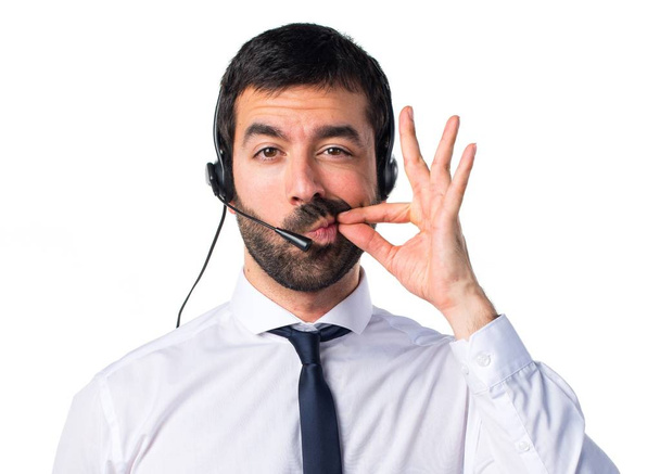 Young man with a headset making silence gesture - Photo, Image