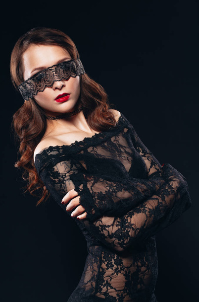 Sexy girl in black lingerie on black background. Erotic photoshoot charming attractive woman with a blindfold mask on her face. Perfect ass and beautiful makeup - Foto, Imagen